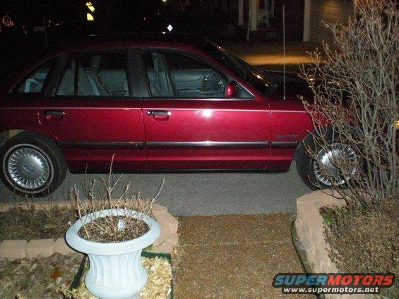 1994 Ford Crown Victoria parked on a driveway at night, side view