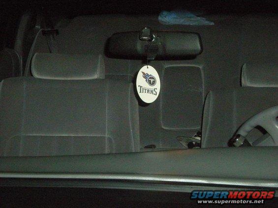 Interior of car with Titans air freshener and fabric seats
