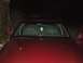 1994 Ford Crown Victoria - Front view of a red 1994 Ford Crown Victoria at night, showing the interior and hood.