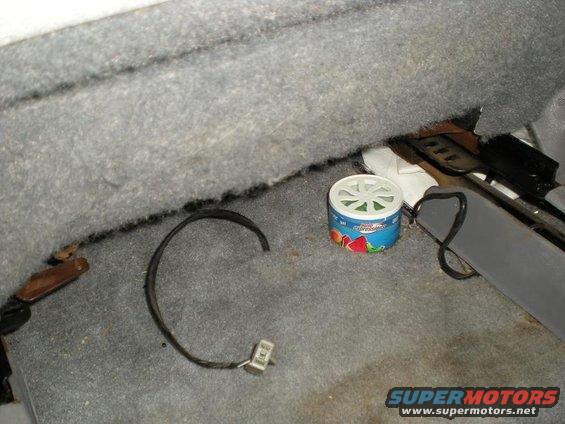 Car floor with a wire and a fruit-scented air freshener