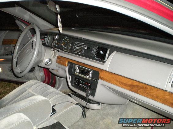 1994 Ford Crown Victoria interior, gray cloth seats, wood trim dashboard, aftermarket stereo