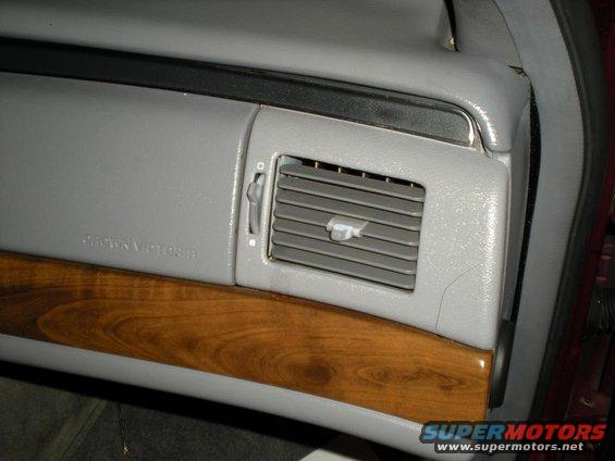 Gray dashboard vent and wood trim with "Crown Victoria" text visible
