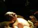 1994 Ford Crown Victoria - A newborn baby is shown crying during its birth, with medical professionals attending.