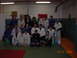 1984 Ford Bronco - A group of martial artists, some in gis, pose for a group photo in a training facility.