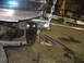 1995 Ford C-350 (Centurion Conversions) - A custom bracket is being installed on the vehicle's frame, possibly for suspension modification.