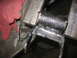 1995 Ford C-350 (Centurion Conversions) - A vehicle part is secured in a vise, possibly for repair or modification.