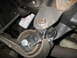 1995 Ford C-350 (Centurion Conversions) - Close-up view of a vehicle's suspension part and an oil filter, likely taken during maintenance or repair.