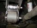 1995 Ford C-350 (Centurion Conversions) - Detail of a vehicle's suspension system, showing a bushing and mounting hardware, with an oil filter in the background.