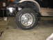 1995 Ford C-350 (Centurion Conversions) - Truck front wheel and suspension components are visible with the bumper removed.