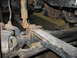 1995 Ford C-350 (Centurion Conversions) - This photo shows a close-up view of a vehicle's suspension system, focusing on the leaf springs and shock absorber.