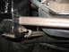 1995 Ford C-350 (Centurion Conversions) - Underside view of a vehicle's suspension system, focusing on the leaf spring and related hardware.