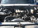 1987 Ford Bronco - The engine bay of a vehicle, with a "CAUTION FAN" shroud prominently displayed.