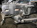 1995 Ford C-350 (Centurion Conversions) - Close-up view of a vehicle's front suspension system, showing a leaf spring and mounting bracket.