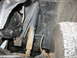 1995 Ford C-350 (Centurion Conversions) - This image shows a close-up view of the suspension system, including a shock absorber and various metal components.