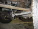 1995 Ford C-350 (Centurion Conversions) - Close-up view of the suspension system and undercarriage of a heavy-duty truck.