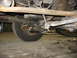 1995 Ford C-350 (Centurion Conversions) - A close-up view of the undercarriage reveals suspension and drivetrain parts, including the driveshaft and sway bar.