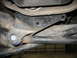 1995 Ford C-350 (Centurion Conversions) - A close-up view of a vehicle's suspension system, focusing on a bracket and linkage.