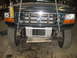 1995 Ford C-350 (Centurion Conversions) - Frontal view of a dark green 1995 Ford C-350 (Centurion Conversions) with its grille and exposed radiator.