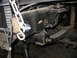1995 Ford C-350 (Centurion Conversions) - This photo shows a close-up view of a vehicle's suspension system, focusing on a leaf spring and its mounting bracket.