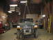 1995 Ford C-350 (Centurion Conversions) - Front view of a 1995 Ford C-350 (Centurion Conversions) being hoisted in a workshop.