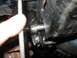 1995 Ford C-350 (Centurion Conversions) - Detail of a vehicle's suspension system, showing a bolt passing through a bracket and bushing.