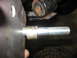 1995 Ford C-350 (Centurion Conversions) - A close-up view shows a threaded bolt extending from a metal plate, with a suspension component visible in the background.