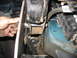 1995 Ford C-350 (Centurion Conversions) - A hand is shown installing a suspension component onto a vehicle's frame.