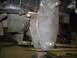 1995 Ford C-350 (Centurion Conversions) - A custom-fabricated metal bracket is attached to the underside of a vehicle, likely for suspension modification.