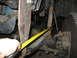 1995 Ford C-350 (Centurion Conversions) - A yellow tape measure is used to check the clearance on a modified vehicle suspension component.