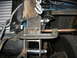 1995 Ford C-350 (Centurion Conversions) - Vehicle frame modification in progress, showing a C-clamp securing metal components. A tire is visible.