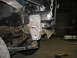 1995 Ford C-350 (Centurion Conversions) - A close-up view of a custom-fabricated bracket attached to the front frame of a vehicle.