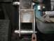 1995 Ford C-350 (Centurion Conversions) - Close-up view of a custom-fabricated suspension part, likely for off-road modification.