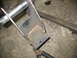 1995 Ford C-350 (Centurion Conversions) - Close-up of a custom-fabricated metal suspension part, showing welding and hardware.