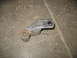 1995 Ford C-350 (Centurion Conversions) - A single metal suspension part with bushings is shown on a concrete floor.