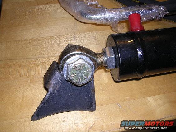 Black hydraulic cylinder with a metal bracket and bolt assembly