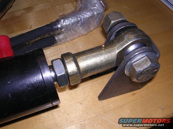 Close-up of an automotive part with hoses and metal fittings