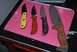 1991 Ford Bronco - A collection of four knives, each with a distinct handle design, are displayed on a flat surface.
