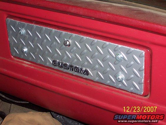 Diamond plate trim with CUSTOM badge on red interior panel
