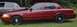 2000 Ford Crown Victoria - A red Ford Crown Victoria is parked on grass, with another car visible behind it.