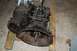 1994 Ford Bronco - A transmission and transfer case assembly is shown, mounted on wooden blocks for support.