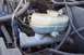 1990 Ford Bronco - Close-up of a Ford brake master cylinder and fluid reservoir, showing various hoses and wiring.