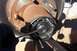 1990 Ford Bronco - A gloved hand uses tools to adjust the internal components of a vehicle's manual locking hub assembly.