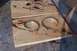 1990 Ford Bronco - Two CV axle boot clamps are shown on a stained wooden board, possibly removed from a vehicle.
