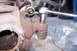 1990 Ford Bronco - Close-up of a worn ball joint being worked on, with a socket wrench in place.