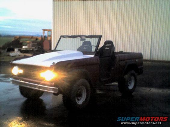 1968 Ford Bronco with a white aftermarket hood and racing seats
