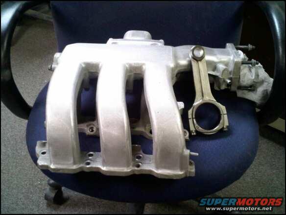 intake manifold and connecting rod on a chair