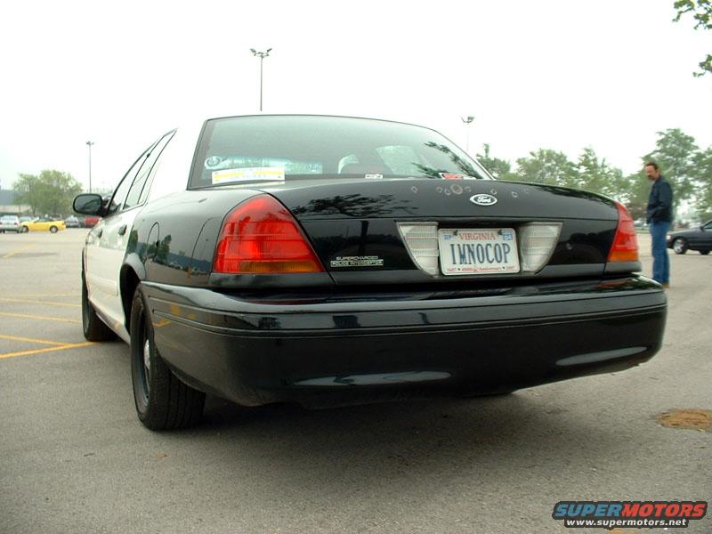 Rear view of a black and white 2000 Ford Crown Victoria police car with a Virginia license plate