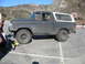 1987 Ford Bronco - This 1978 Ford Bronco is seen from the side in a parking lot with mountains in the background.