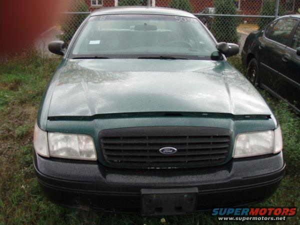 Front view of a dark sedan with a black grille