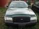 2000 Ford Crown Victoria - Frontal view of a dark sedan, possibly a police car, with a black grille and headlights visible.